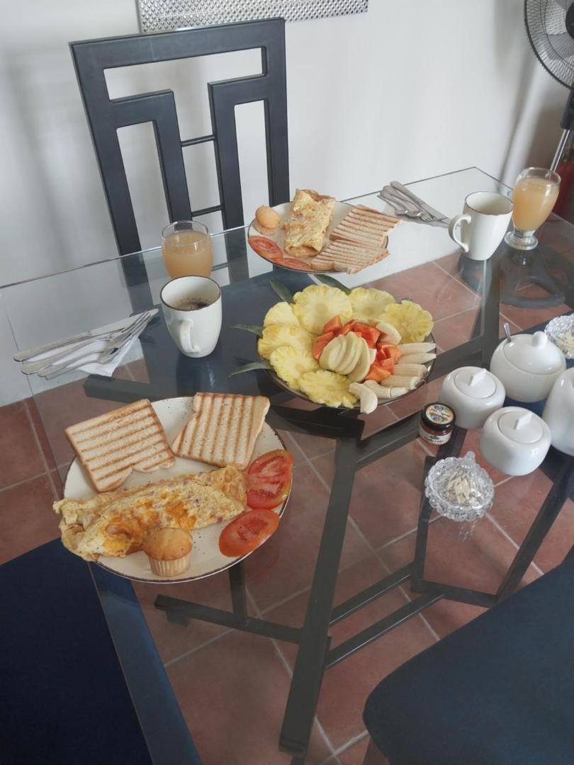Breakfast table with toast, eggs, fruit and juice